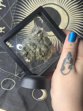 Load image into Gallery viewer, Clear quartz cluster with pyrite peacock ore specimen in black floating frame
